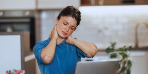 Woman stretching her upper back